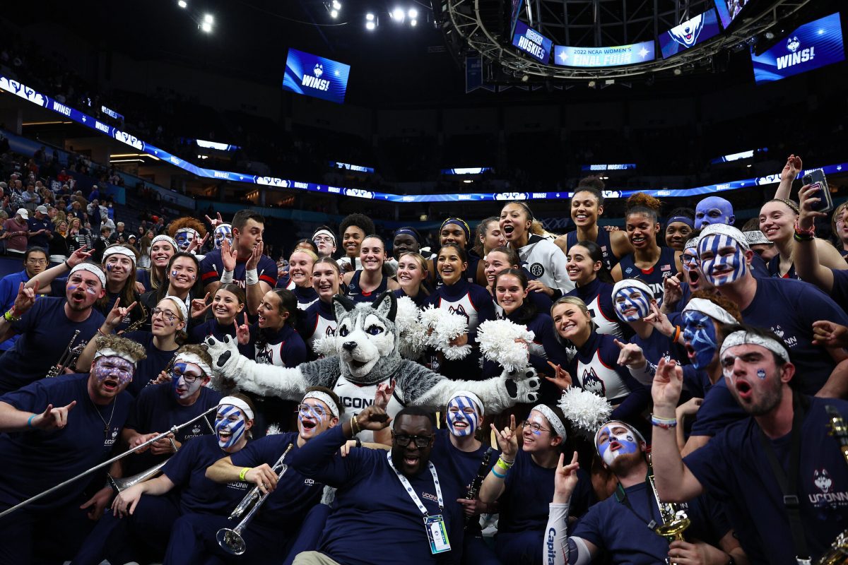 UConn Pep Band members celebrate with the UConn Women's Basketball team