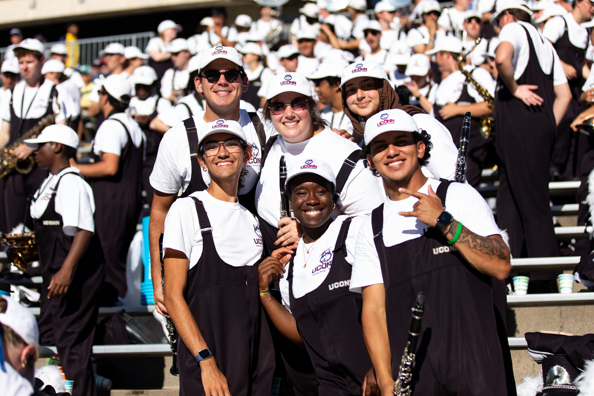 UConn Marching Band members pose together in the stands