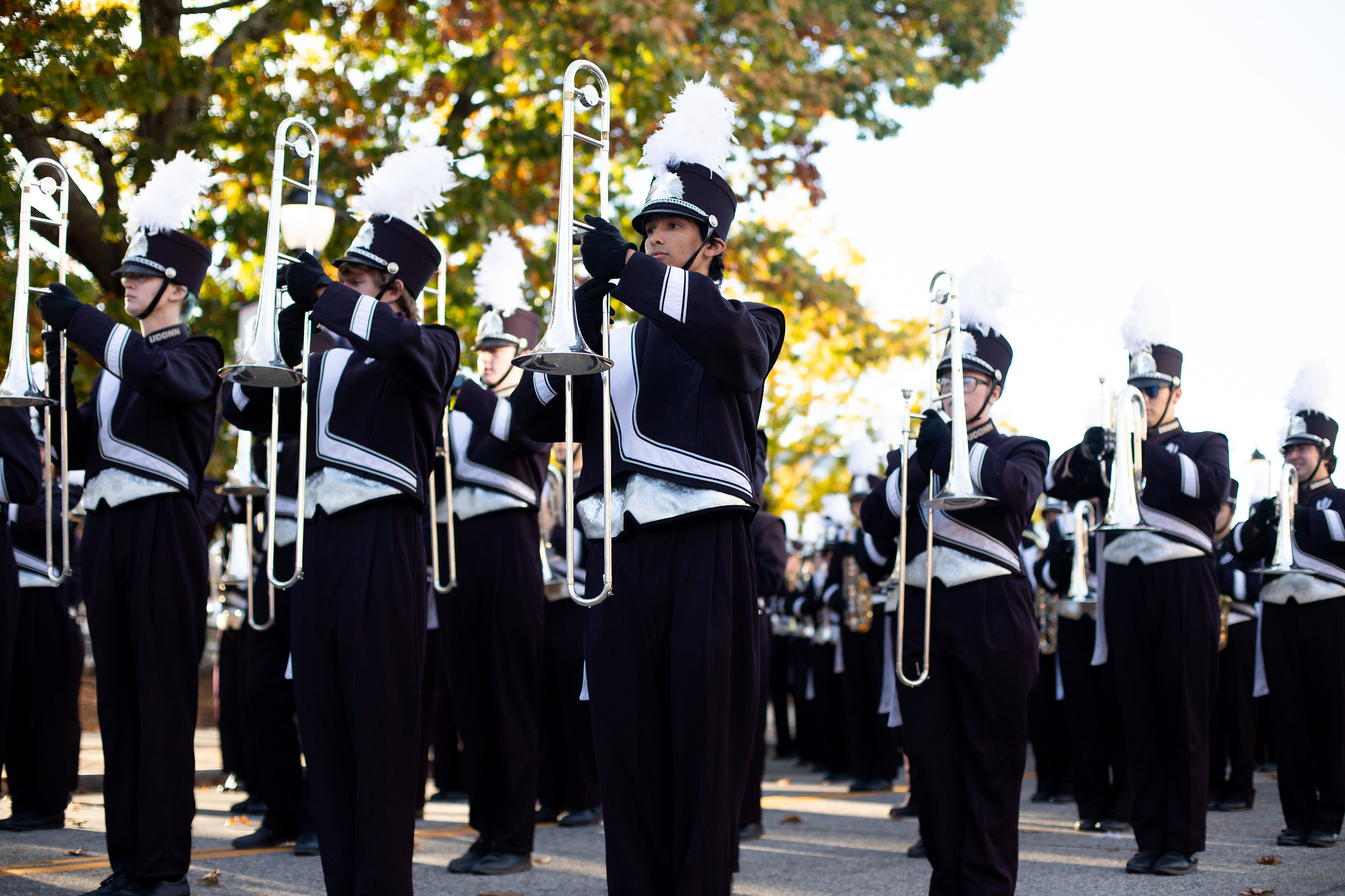 UConn Marching Band trombone section marching in a parade